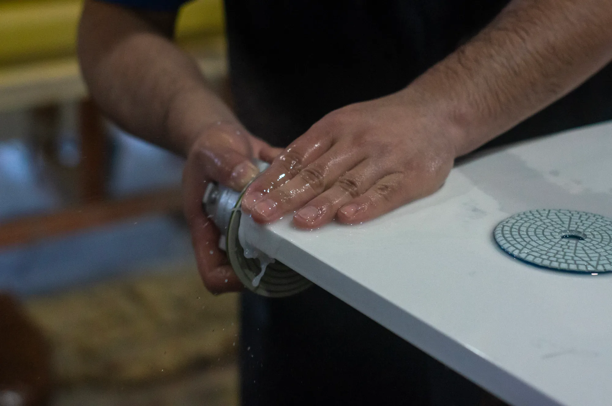 Hand finishing a stone edge in the fabrication workshop